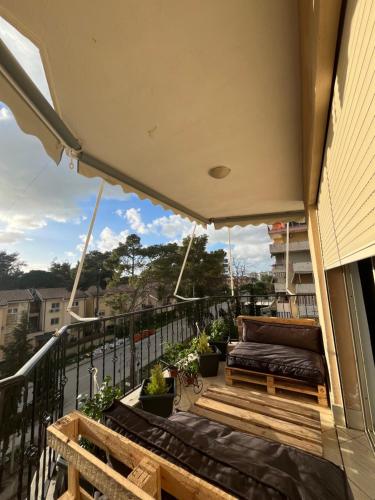 a balcony with benches and plants on a building at Bega's Apartment in Golem, Durrës in Golem