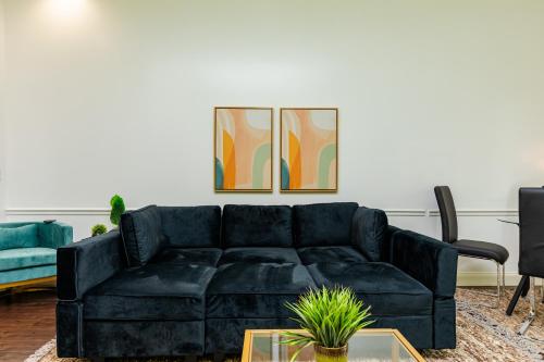 a black couch in a living room with a table at 30-A Inn & Suites in Santa Rosa Beach