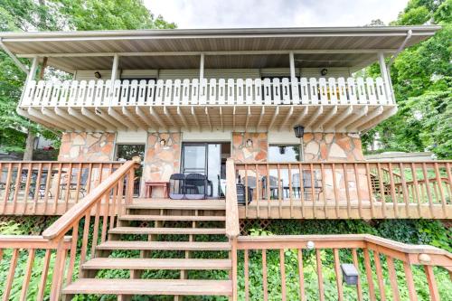 a house with a deck and stairs leading up to it at Deck and Boat Dock Lakefront Getaway in Camdenton in Camdenton