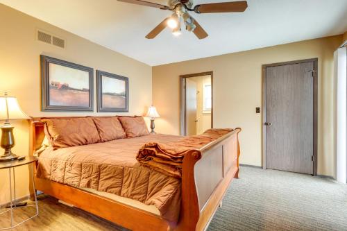a bedroom with a bed and a ceiling fan at Deck and Boat Dock Lakefront Getaway in Camdenton in Camdenton