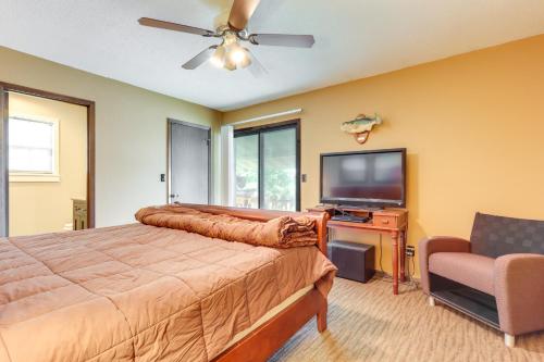 a bedroom with a bed and a flat screen tv at Deck and Boat Dock Lakefront Getaway in Camdenton in Camdenton