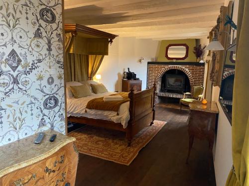 a bedroom with a bed and a fireplace at Moon River Bellac Chambre d'hotes in Bellac