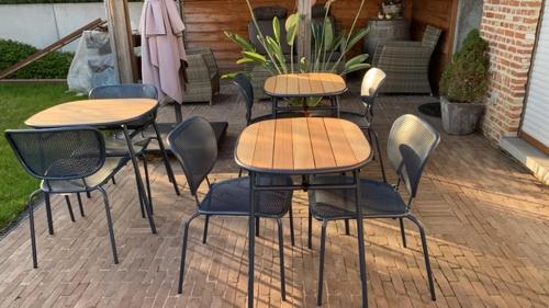 a group of tables and chairs on a patio at Casa della Nonna in Zwalm