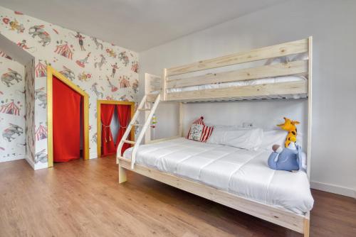 a bedroom with a bunk bed with a ladder at Villa Elia, Cinema, Gym, KidsRoom, Pool & BBQ in La Eliana