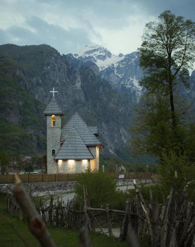 a small church with a cross on top of it at Thethi Villas in Theth