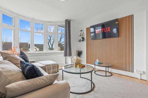 a living room with a couch and two tables at Cosy 2 bed flat, Wembley Stadium in London