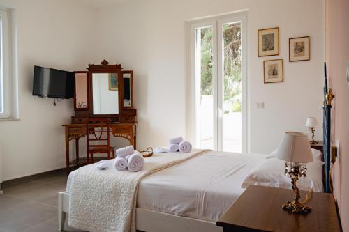 a bedroom with a bed with towels on it at Villa Rubino Mondello Guest house - By Rentalbeb Italy in Palermo