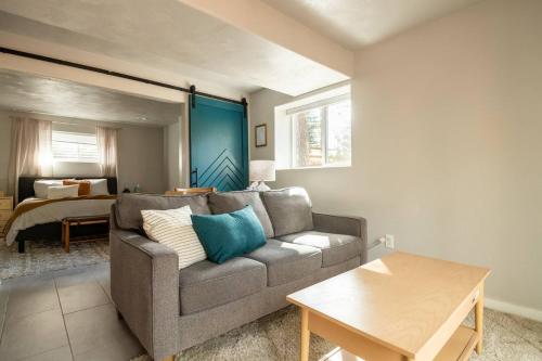 a living room with a couch and a bedroom at Cozy Getaway - Perfect Base for Exploring Colorado Springs in Colorado Springs