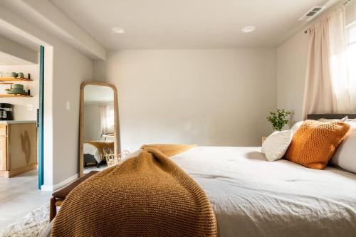 a bedroom with a large bed and a mirror at Cozy Getaway - Perfect Base for Exploring Colorado Springs in Colorado Springs