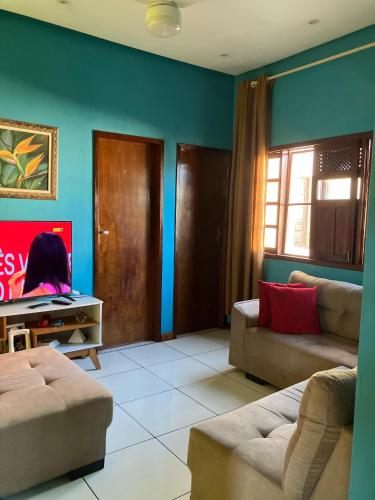 a living room with blue walls and couches at Hospedagem da Miss in Lençóis