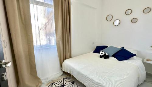 a bedroom with a panda bear pillow on a bed at Beautyful Resort Apartment in Haifa