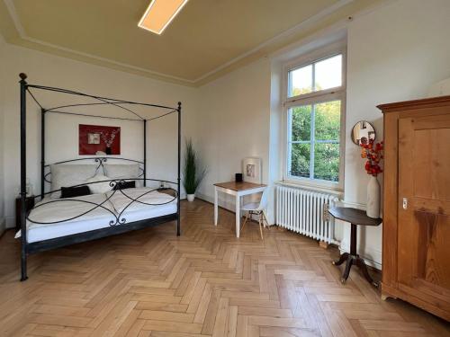 a bedroom with a bed and a desk and a window at theMAP in Lenzkirch