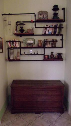 a room with shelves and a wooden bench on a wall at La casetta rossa in Collicello