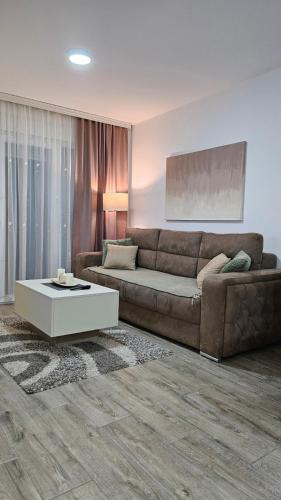 a living room with a couch and a coffee table at Silver Dream 2 in Veliko Gradište