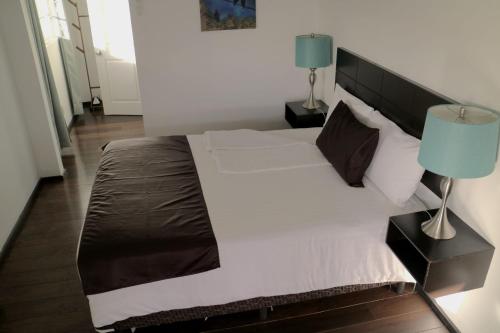 a bedroom with a large bed with a blue lamp at Quinta Sofia Valle de Guadalupe in Valle de Guadalupe