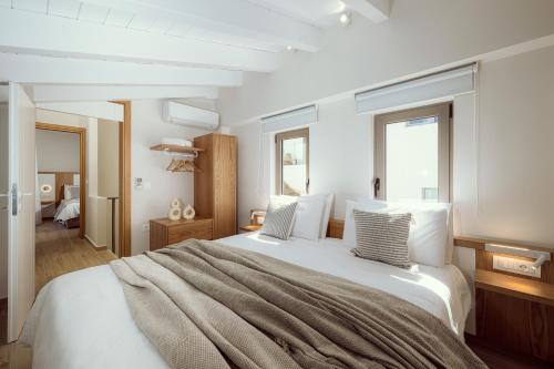 Ένα ή περισσότερα κρεβάτια σε δωμάτιο στο Ethereal White Villas