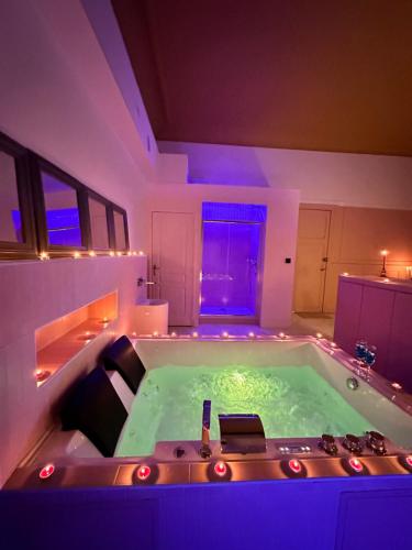 a jacuzzi tub in the middle of a room at PINK ROOm in Tourcoing
