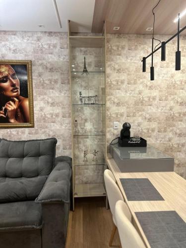 a dining room with a table and a couch at Studio completo e bem localizado in Jaú