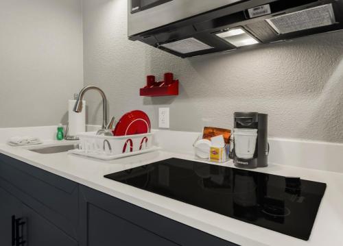 a kitchen with a sink and a counter top at Hawthorn Extended Stay by Wyndham College Station in College Station