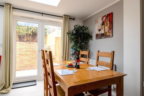 a dining room with a wooden table and chairs at Peakstone House in Sheffield