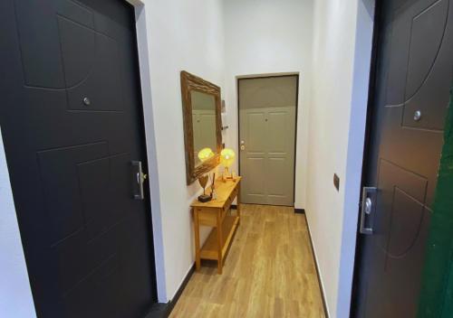 a hallway with a black door and a mirror at C'era un Voltino Guest House in Borgonovo