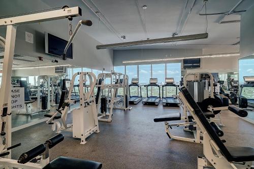 a gym with several treadmills and machines in it at Breathtaking Direct Bay Views 2 bedroom condo with parking in Miami