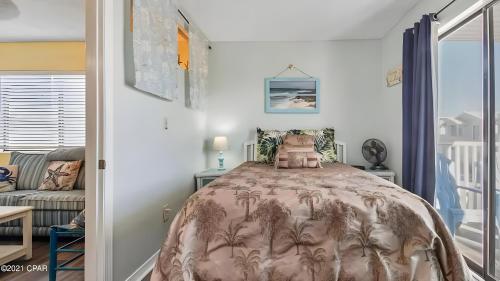 a bedroom with a bed with palm trees on it at Across the Street from beach with 2 pools in Panama City Beach