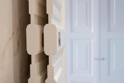 a room with two white doors and a window at Villino Peca in Forte dei Marmi