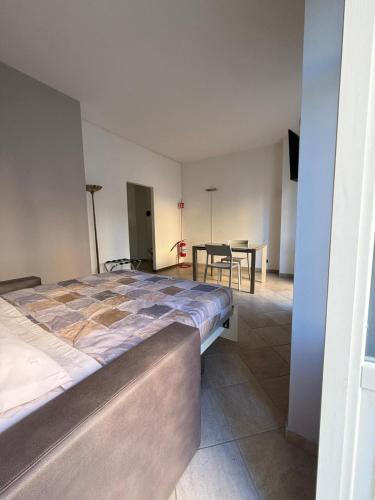a bedroom with a large bed and a table at Incentro a Chivasso in Chivasso