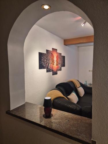 a living room with a couch in a mirror at Bella Hiša in Sromlje