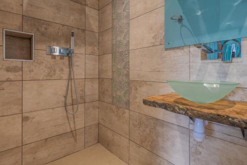 a bathroom with a shower and a sink at Tredodridge Barn Retreat in Saint Nicholas