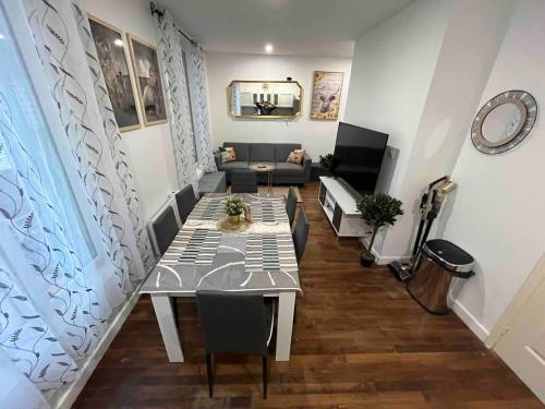 a living room with a table and a couch at KXX Private complex 15 min PARIS ParcExpo 12 bedrooms in Bagneux