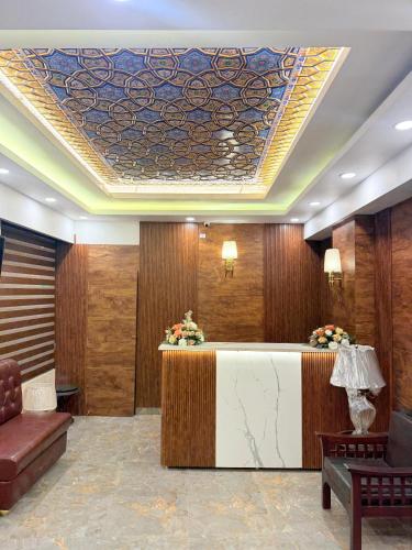 a hotel lobby with a reception desk with a ceiling at SkyRidges in Srinagar