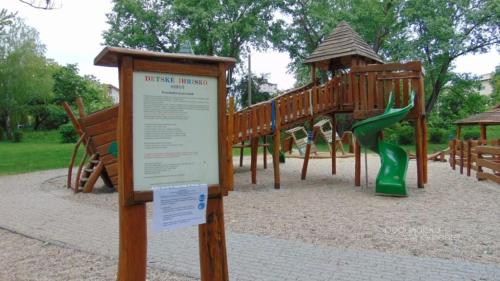 a park with a playground with a slide at Apartmán pri mlyne in Nové Zámky