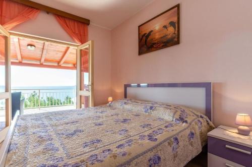 a bedroom with a bed and a large window at House Vila Petra in Blato