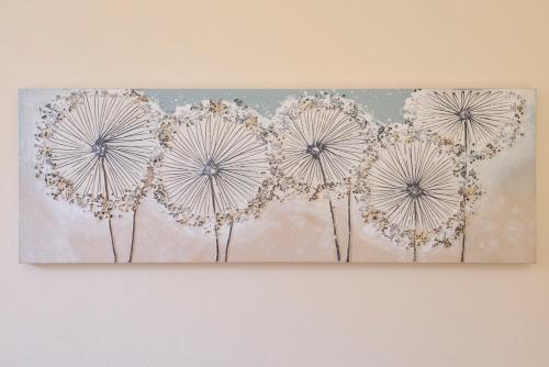 a painting of dandelions on a wall at Wellness Penzion U Muzea in Liberec