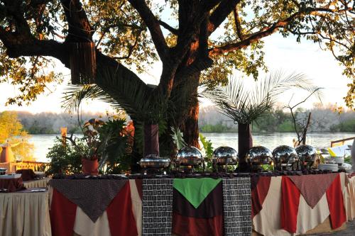 a table with balls on it next to a lake at The David Livingstone Safari Lodge & Spa in Livingstone