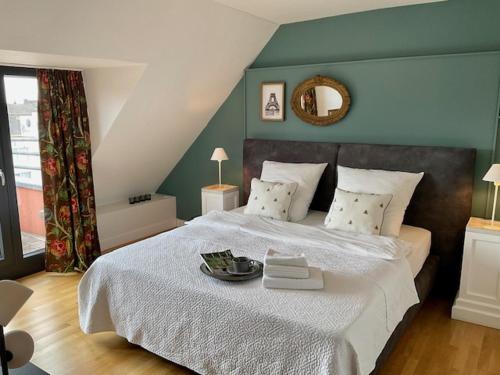 a bedroom with a large bed with a plate on it at Charmante Penthouse Wohnung in Krefeld