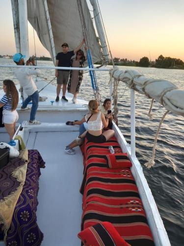 a group of people on a sail boat in the water at جزيرة العوامية in Luxor