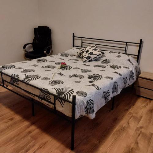 a bed with a black and white comforter on it at Camera "Il Giarasole" in Pistoia