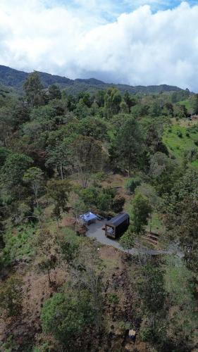 an aerial view of a field with a truck at Tiny House Minimalista en la Naturaleza, El Retiro in El Retiro