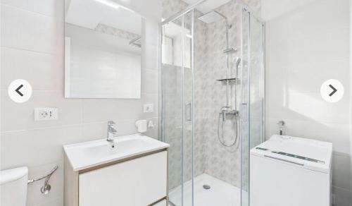 a bathroom with a shower and a sink and a toilet at Unique apartments in Timişoara