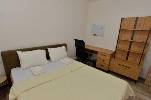 a bedroom with a bed and a desk and a desk at Apartments Boka bay in Kotor