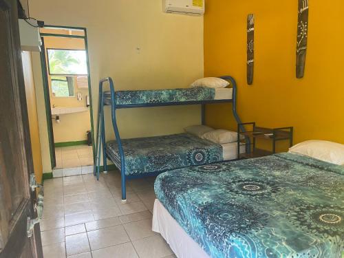 a room with two bunk beds and a mirror at Cabinas Manzanillo Caribe in Manzanillo