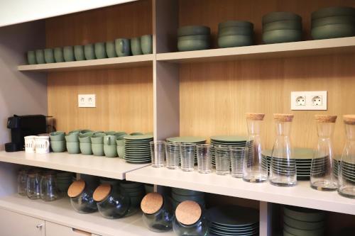 a shelf with plates and glasses on it at Hotel Bermeo in Bermeo