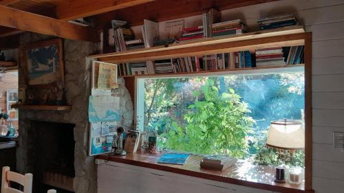 a window in a room with a table and a lamp at Dodo House in Villa La Angostura