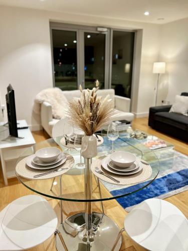 a living room with a glass table and chairs at Auracasa 2 Bed O2 Canning suite in London