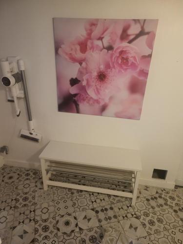 a white bench in a room with a picture on the wall at L'Escale 3 Chambres Clermont-Ferrand in Clermont-Ferrand