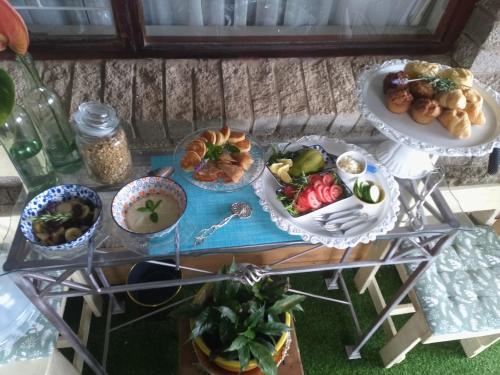a glass table with plates of food on it at Addo River Den in Gqeberha
