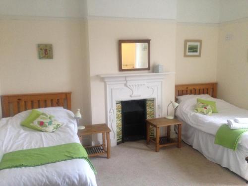 a bedroom with a bed and a fireplace at Old Church House in Newport